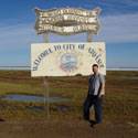 Mike in front of the "Welcome to Atqasuk" sign.